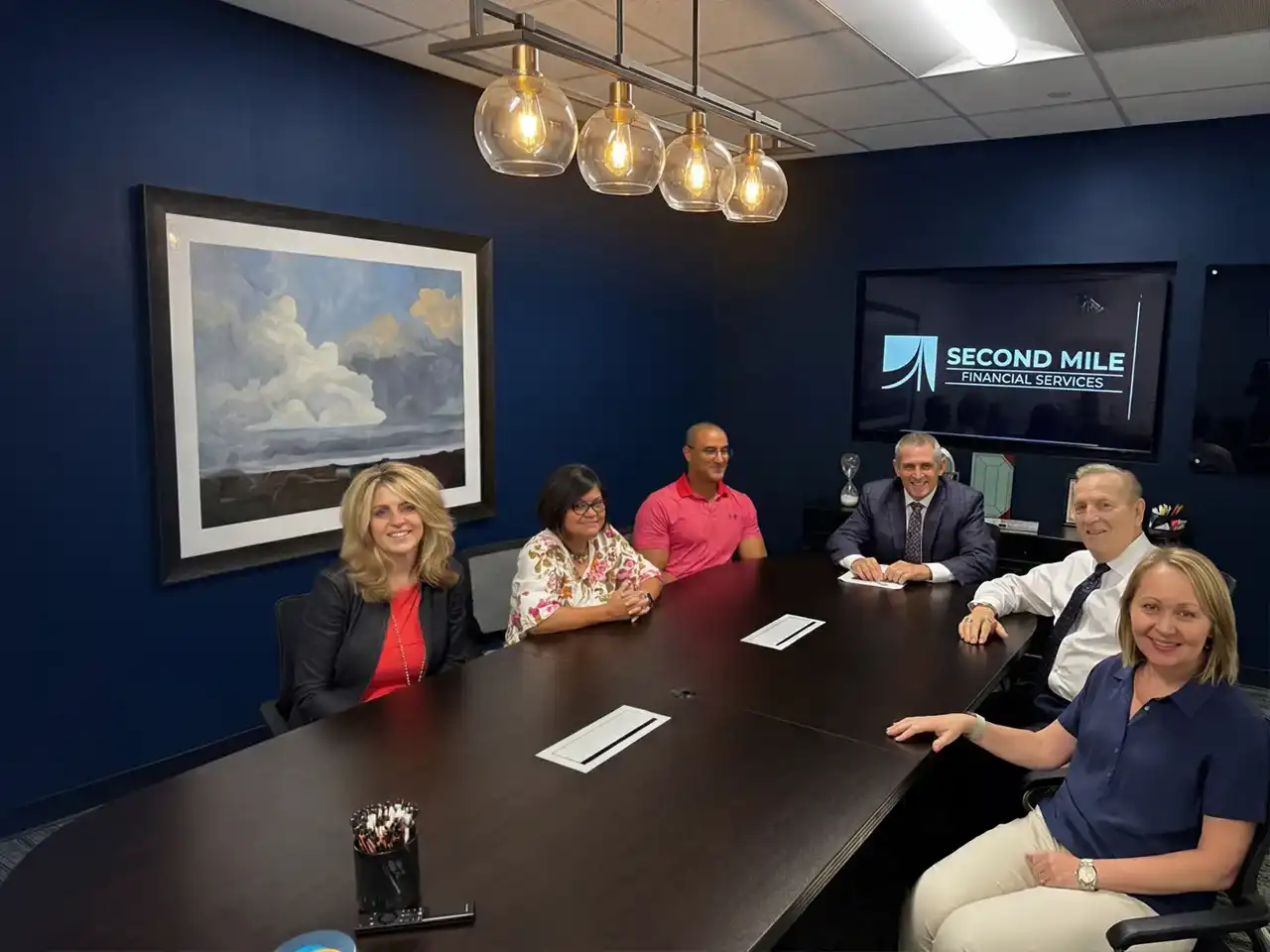 The Second Mile Financial leadership team led by Dr. John Wesevich CPA collaborating on client business architecture plus strategic tax planning.