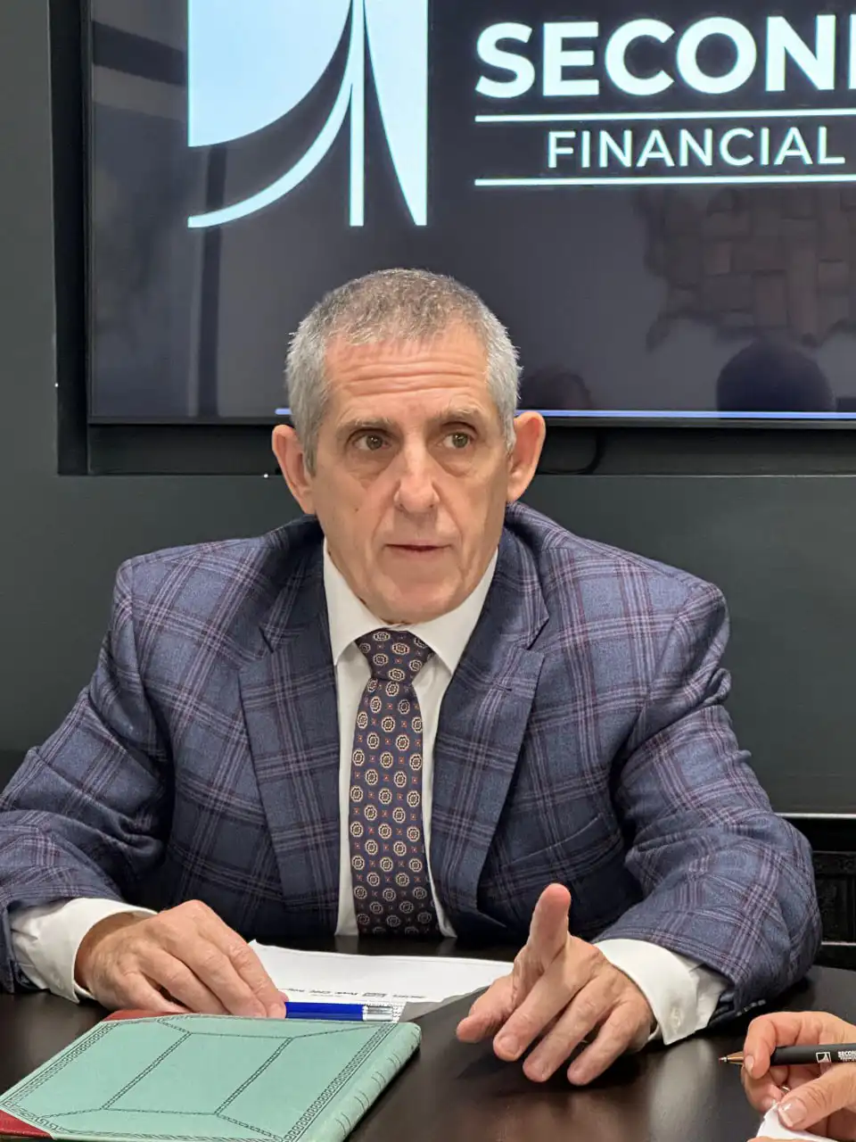 Dr. John Wesevich providing professional financial leadership during a boardroom strategy session with business owners.